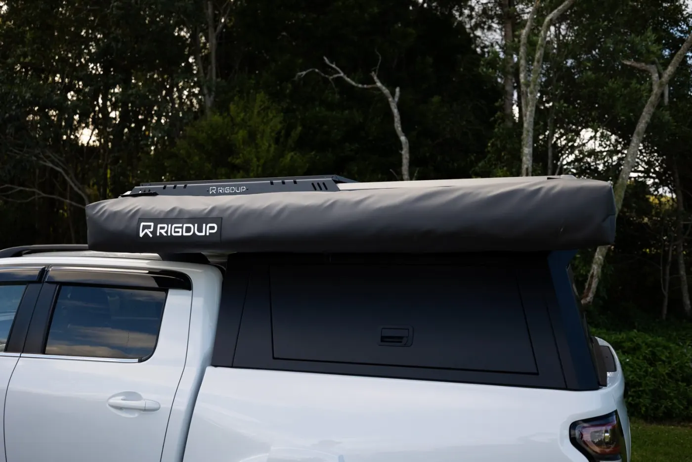 Rigdup awning packed on a white ute at the edge of the bush