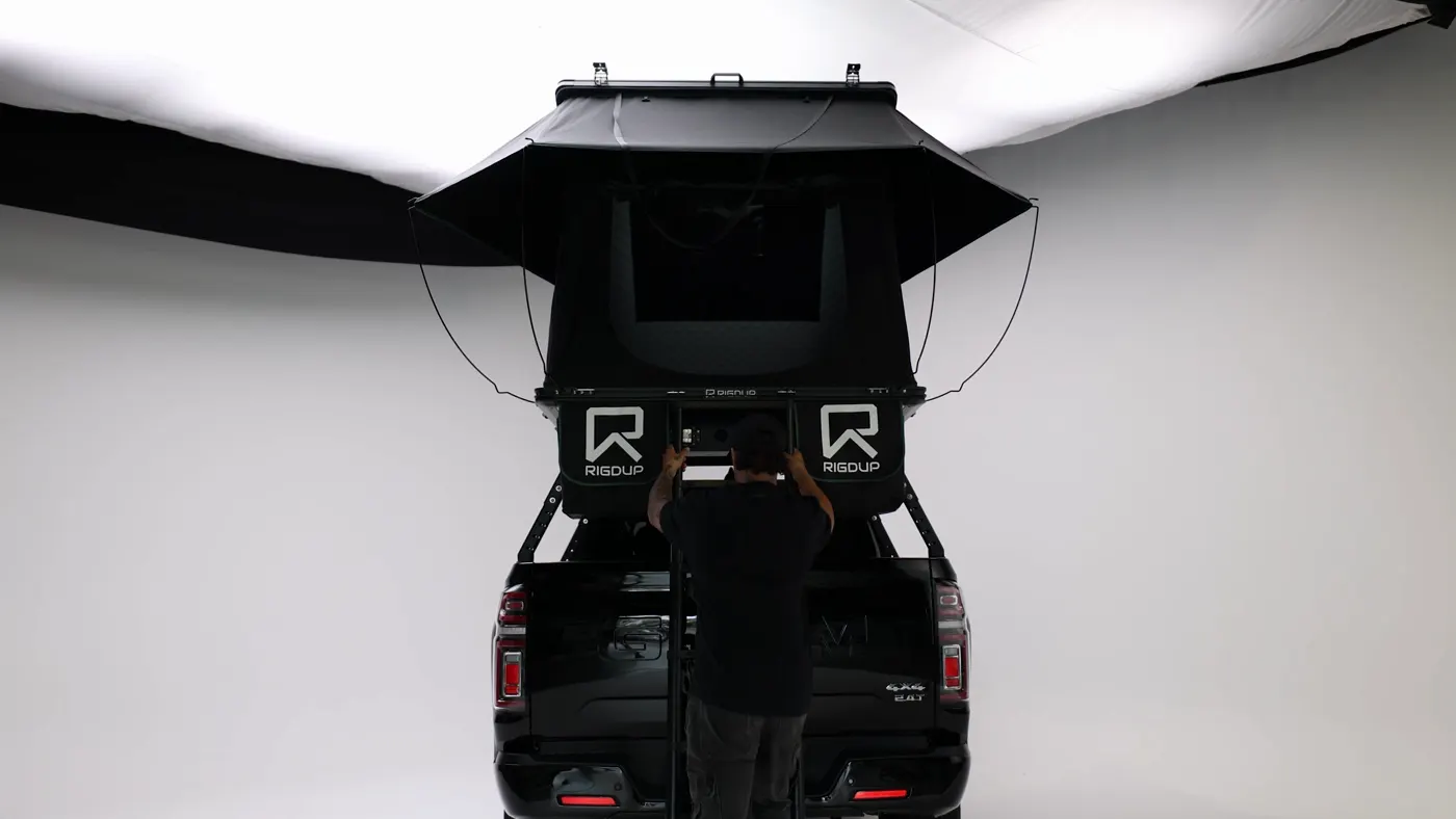 Hardshell tent open on the back of a ute