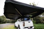 Rigdup 270 degree awning opened out over a white GWM ute, showing integrated LED light strips underneath